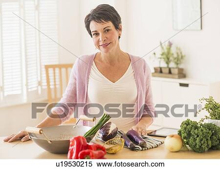 Portrait of mature woman in kitchen View Large Photo Image Stock Photography - Portrait of mature woman in kitchen. Fotosearch