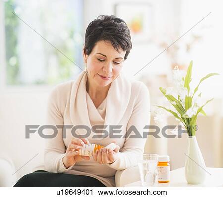 Portrait of mature woman taking pills View Large Photo Image Stock Image - Portrait of mature woman taking pills. Fotosearch