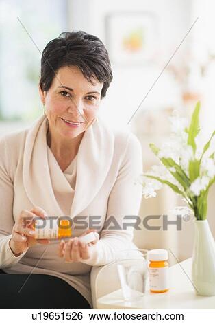 Portrait of mature woman taking pills View Large Photo Image Stock Photograph - Portrait of mature woman taking pills. Fotosearch