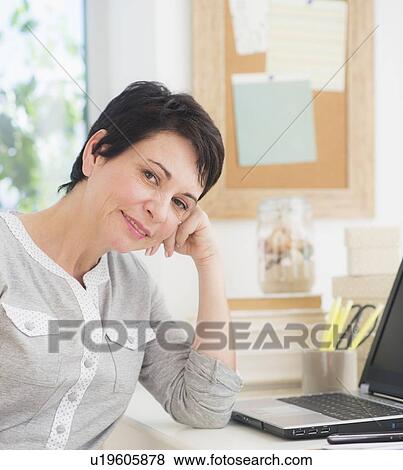 Portrait of mature woman using laptop View Large Photo Image Stock Photo - Portrait of mature woman using laptop. Fotosearch