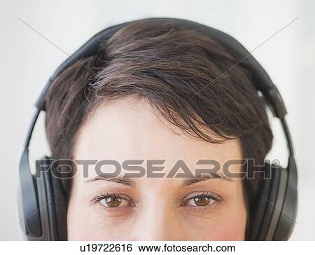 Portrait of mature woman wearing headphones View Large Photo Image Stock Photograph - Portrait of mature woman wearing headphones. Fotosearch
