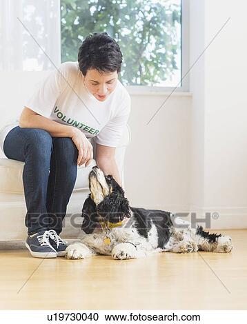 Stock Image - Portrait of mature woman with dog. Fotosearch
