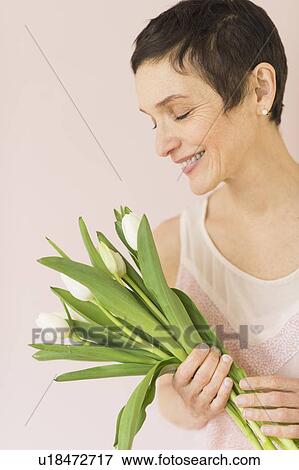 Portrait of mature woman with tulips View Large Photo Image Stock Photo - Portrait of mature woman with tulips. Fotosearch
