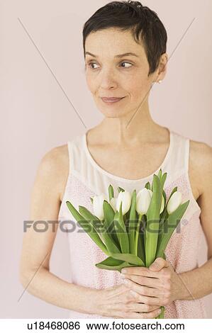 Portrait of mature woman with tulips View Large Photo Image Stock Photograph - Portrait of mature woman with tulips. Fotosearch
