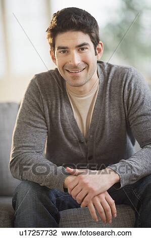 Stock Image - Portrait of mid adult man at home. Fotosearch