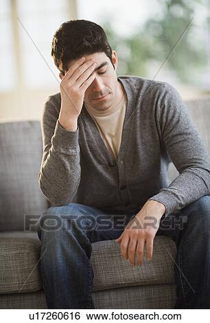 Stock Photograph - Portrait of mid adult man at home. Fotosearch