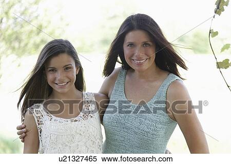 Stock Photography - Portrait of mother and daughter (12-13). Fotosearch