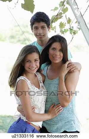 Stock Photograph - Portrait of mother with daughter (12-13) and son (14-15). Fotosearch