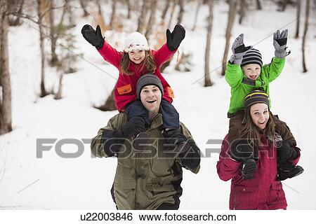 Stock Photograph - Portrait of parents carrying children (2-3, 4-5) on shoulders . Fotosearch