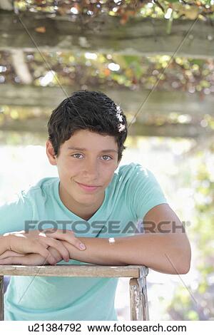 Stock Image - Portrait of teenage boy (14-15). Fotosearch