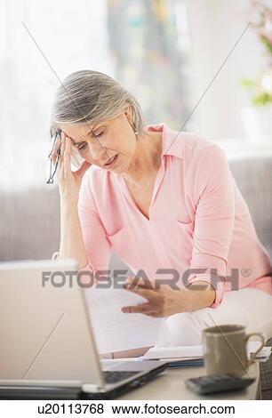 Portrait of uncertain woman doing paperwork View Large Photo Image Stock Photo - Portrait of uncertain woman doing paperwork. Fotosearch