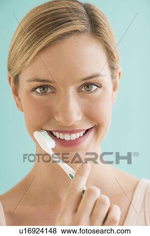 Portrait of woman brushing teeth View Large Photo Image Stock Photo - Portrait of woman brushing teeth. Fotosearch
