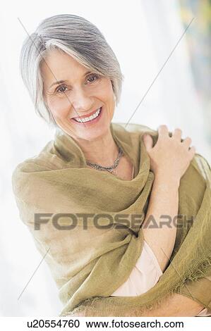 Stock Image - Portrait of woman covered with scarf. Fotosearch