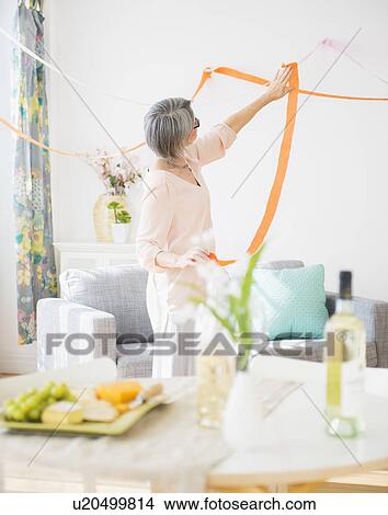 Portrait of woman decorating living room View Large Photo Image Picture - Portrait of woman decorating living room. Fotosearch