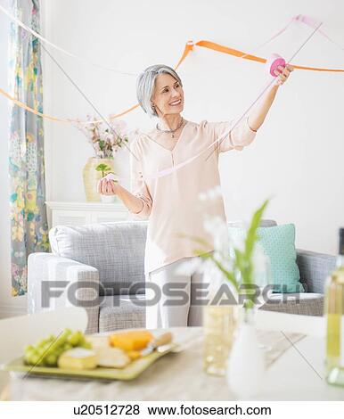 Portrait of woman decorating living room View Large Photo Image Stock Photo - Portrait of woman decorating living room. Fotosearch