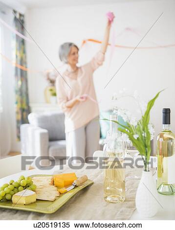 Portrait of woman decorating living room View Large Photo Image Stock Photography - Portrait of woman decorating living room. Fotosearch