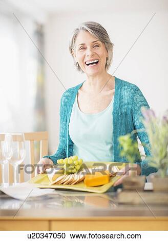Portrait of woman holding appetizer plate View Large Photo Image Stock Image - Portrait of woman holding appetizer plate. Fotosearch