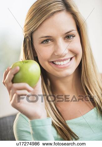 Portrait of woman holding apple View Large Photo Image Stock Photograph - Portrait of woman holding apple. Fotosearch