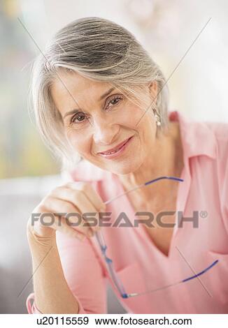 Portrait of woman holding glasses View Large Photo Image Stock Photo - Portrait of woman holding glasses. Fotosearch
