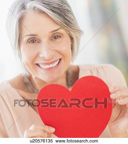 Portrait of woman holding paper heart View Large Photo Image Stock Photography - Portrait of woman holding paper heart. Fotosearch