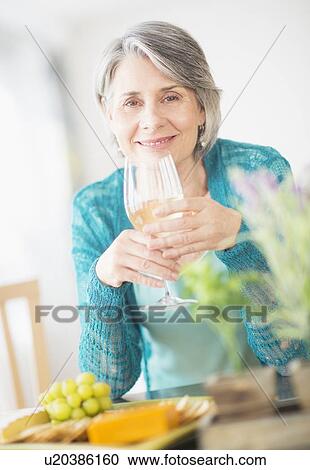 Portrait of woman holding wine glass View Large Photo Image Stock Image - Portrait of woman holding wine glass. Fotosearch