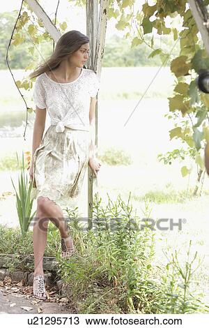 Portrait of woman in dress in garden View Large Photo Image Stock Image - Portrait of woman in dress in garden. Fotosearch