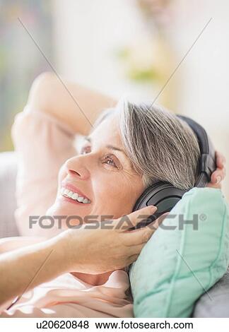 Portrait of woman listening to music View Large Photo Image Stock Photo - Portrait of woman listening to music. Fotosearch
