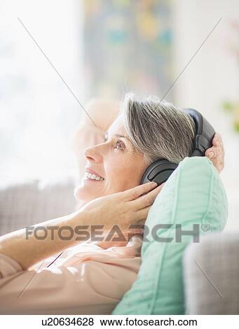 Portrait of woman listening to music View Large Photo Image Stock Photo - Portrait of woman listening to music. Fotosearch