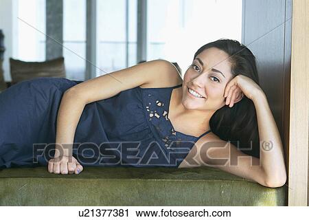 Stock Image - Portrait of woman lying down . Fotosearch