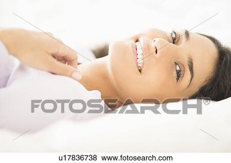 Portrait of woman lying in bed View Large Photo Image Stock Photo - Portrait of woman lying in bed. Fotosearch