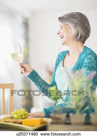Portrait of woman raising wine glass View Large Photo Image Stock Image - Portrait of woman raising wine glass. Fotosearch