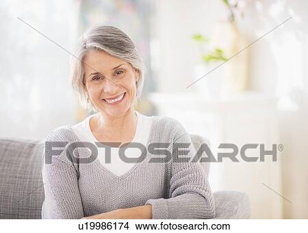 Portrait of woman relaxing on sofa View Large Photo Image Picture - Portrait of woman relaxing on sofa. Fotosearch