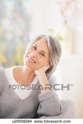 Portrait of woman relaxing on sofa View Large Photo Image Picture - Portrait of woman relaxing on sofa. Fotosearch