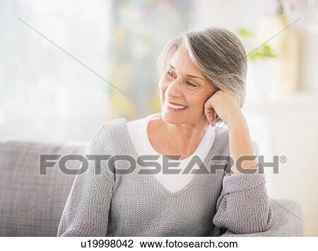 Portrait of woman relaxing on sofa View Large Photo Image Stock Image - Portrait of woman relaxing on sofa. Fotosearch
