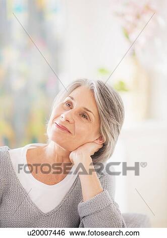 Portrait of woman relaxing on sofa View Large Photo Image Stock Photograph - Portrait of woman relaxing on sofa. Fotosearch