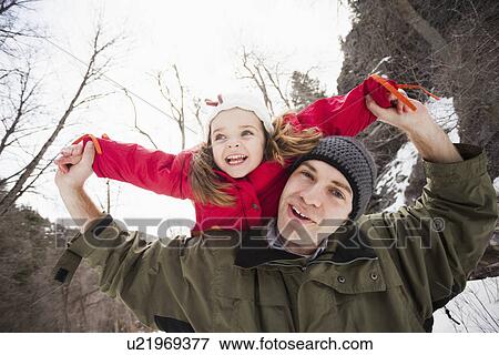 Portrait of young man carrying girl (2-3) on shoulders View Large Photo Image Stock Photo - Portrait of young man carrying girl (2-3) on shoulders . Fotosearch