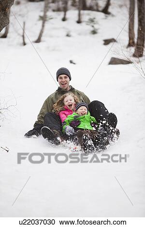 Portrait of young man sledding with children (4-5) View Large Photo Image Stock Image - Portrait of young man sledding with children (4-5). Fotosearch