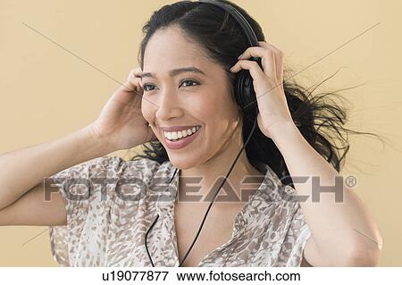 Portrait of young woman in headphones View Large Photo Image Stock Photo - Portrait of young woman in headphones. Fotosearch
