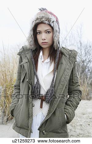 Stock Image - Portrait of young woman in warm clothes. Fotosearch