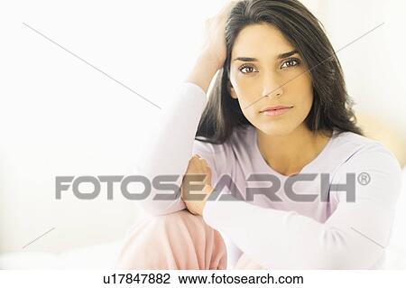 Stock Image - Portrait of young woman smiling. Fotosearch