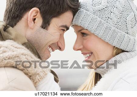 Picture - Profile of couple in winter clothing. Fotosearch