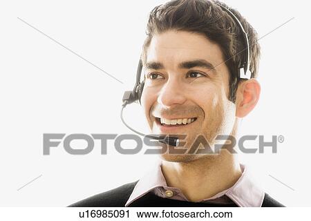 Studio portrait of man wearing headset View Large Photo Image Stock Image - Studio portrait of man wearing headset. Fotosearch