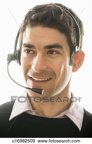 Studio portrait of man wearing headset View Large Photo Image Stock Photo - Studio portrait of man wearing headset. Fotosearch