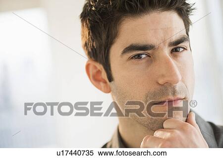 Stock Photography - Studio portrait of mid adult man. Fotosearch
