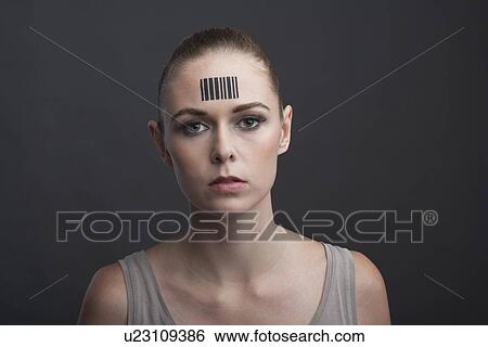 Stock Photograph - Studio portrait of woman with bar code on forehead. Fotosearch