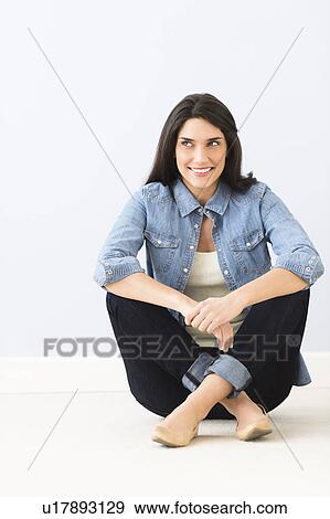 Studio portrait of young woman sitting on floor View Large Photo Image Stock Photo - Studio portrait of young woman sitting on floor. Fotosearch