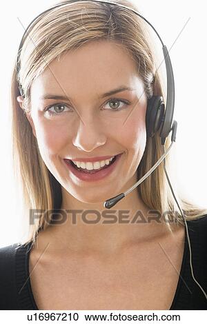 Studio portrait of young woman wearing headset View Large Photo Image Stock Image - Studio portrait of young woman wearing headset. Fotosearch