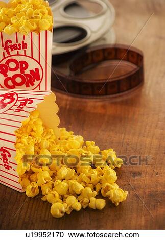 Studio Shot, Film reel and box of popcorn View Large Photo Image Stock Image - Studio Shot, Film reel and box of popcorn. Fotosearch