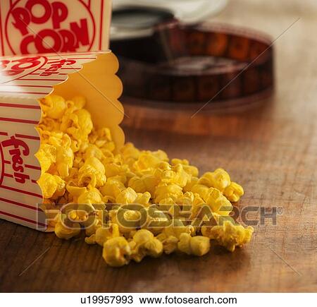 Stock Image - Studio Shot, Film reel and box of popcorn. Fotosearch