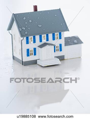 Stock Photo - Studio Shot of artificial house during flood. Fotosearch